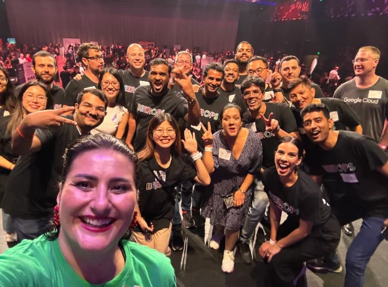 A crowd of community members taking a group selfie at a tech event